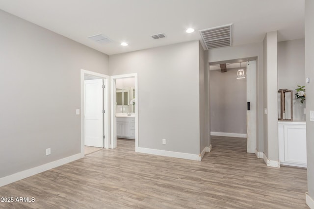 unfurnished room featuring light hardwood / wood-style flooring and sink