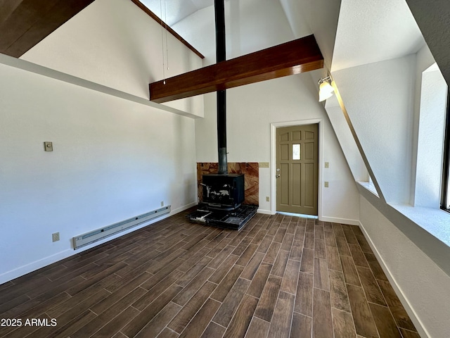 1886 Coyote Pl, Show Low, AZ 85901 - unfurnished living room with a baseboard radiator, dark wood-style flooring, a wood stove, and high vaulted ceiling