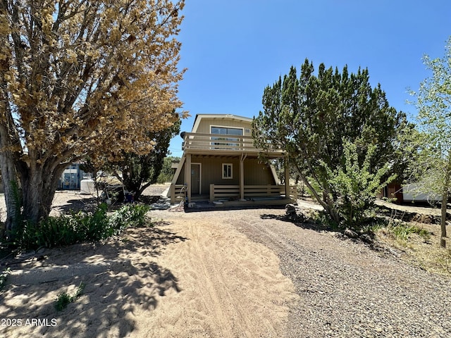 1886 Coyote Pl, Show Low, AZ 85901 - a-frame style home with a porch, dirt driveway, and a balcony