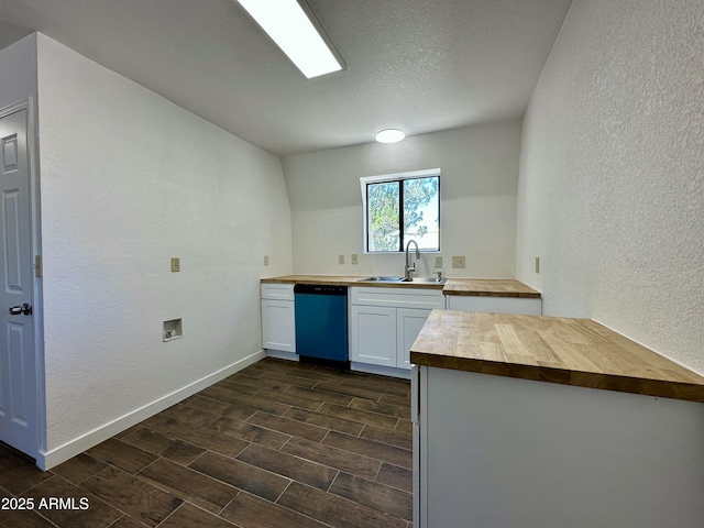 1886 Coyote Pl, Show Low, AZ 85901 - kitchen with dishwasher, wooden counters, a textured wall, white cabinetry, and wood tiled floors