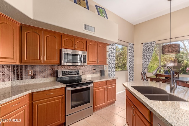 1453 E Elgin Pl, Chandler, AZ 85225 - kitchen featuring stainless steel appliances, a sink, tasteful backsplash, light tile patterned flooring, and decorative light fixtures