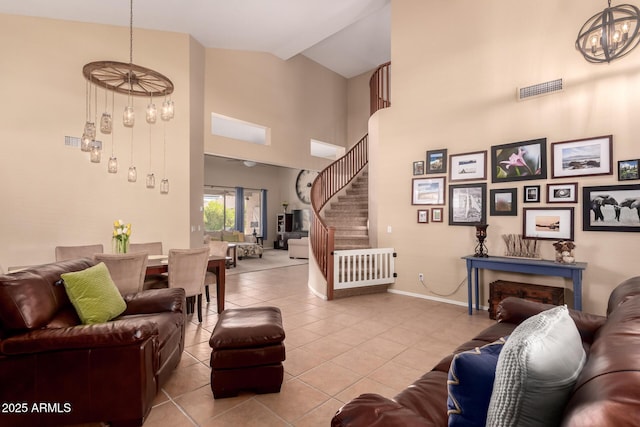 1453 E Elgin Pl, Chandler, AZ 85225 - living area featuring tile patterned floors, a chandelier, stairs, baseboards, and high vaulted ceiling