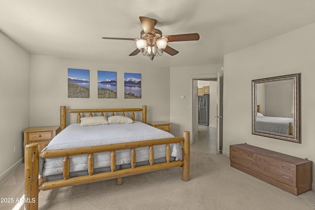 bedroom with ceiling fan, light carpet, and baseboards