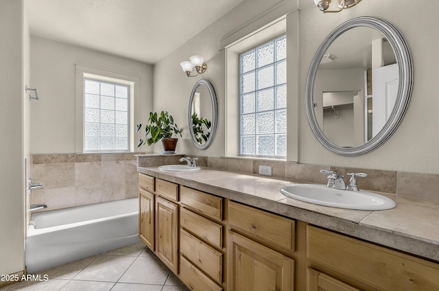 full bathroom with tile patterned flooring, a sink, and plenty of natural light