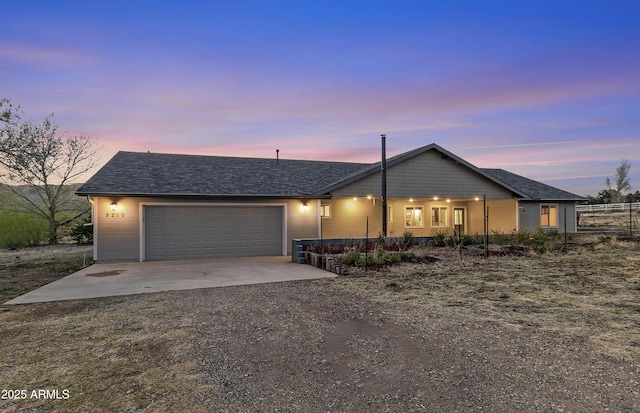 ranch-style home with roof with shingles, covered porch, dirt driveway, and an attached garage