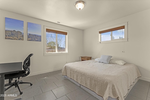 bedroom featuring visible vents, tile patterned floors, and baseboards