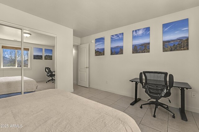 bedroom featuring light tile patterned floors and baseboards