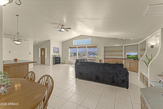 living area featuring visible vents, a ceiling fan, light tile patterned flooring, and lofted ceiling