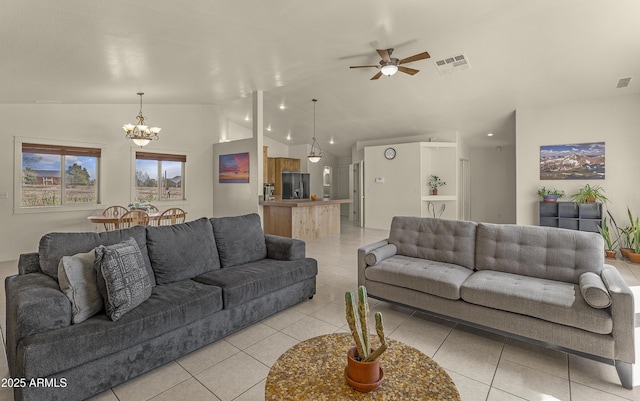 living area with light tile patterned floors, visible vents, vaulted ceiling, and ceiling fan with notable chandelier