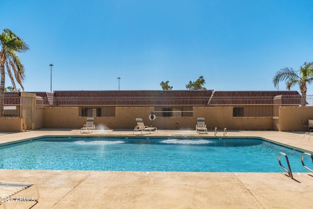 pool featuring a patio area and fence