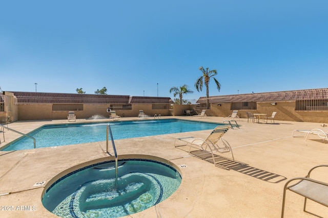 pool featuring fence, a community hot tub, and a patio