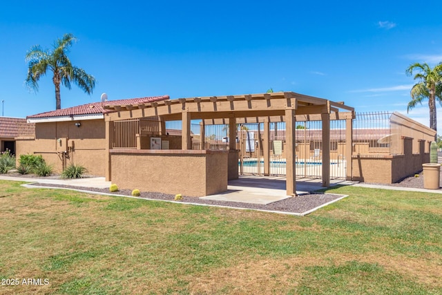 exterior space featuring a yard, fence, a tiled roof, and stucco siding