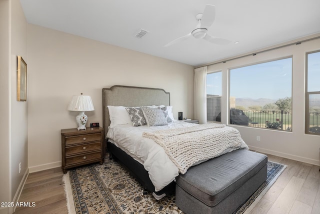 bedroom with hardwood / wood-style flooring and ceiling fan