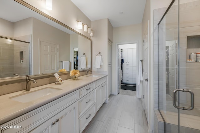 bathroom featuring vanity and an enclosed shower