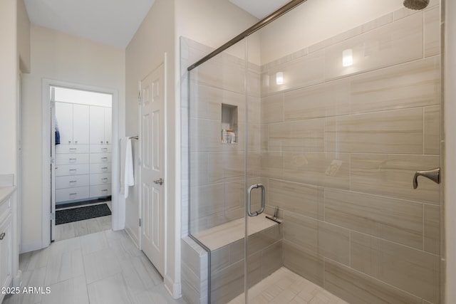 bathroom featuring a shower with shower door