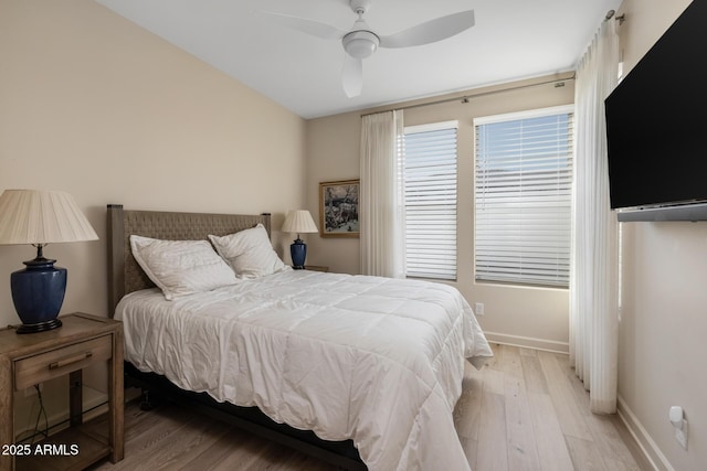 bedroom with ceiling fan and light hardwood / wood-style flooring