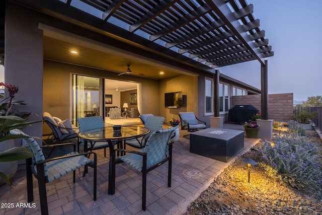 patio terrace at dusk with a grill, a pergola, and an outdoor fire pit