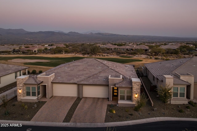 aerial view at dusk featuring a mountain view