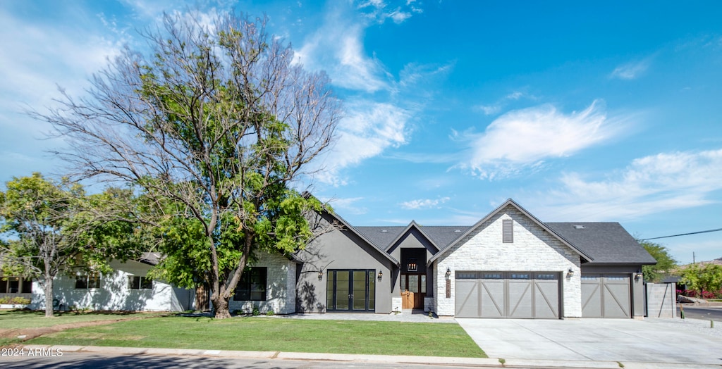 view of front facade with a front lawn and a garage