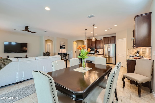 tiled dining area featuring ceiling fan