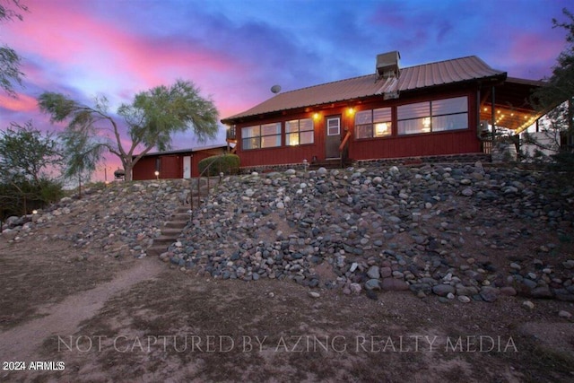 view of back house at dusk