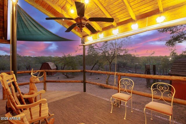 back house at dusk with a porch