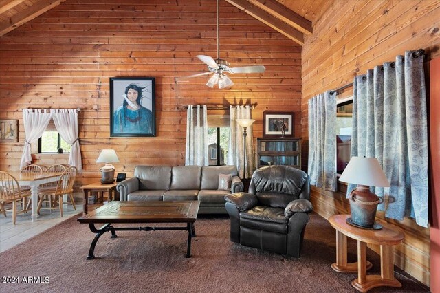 living room with high vaulted ceiling, carpet, and beamed ceiling