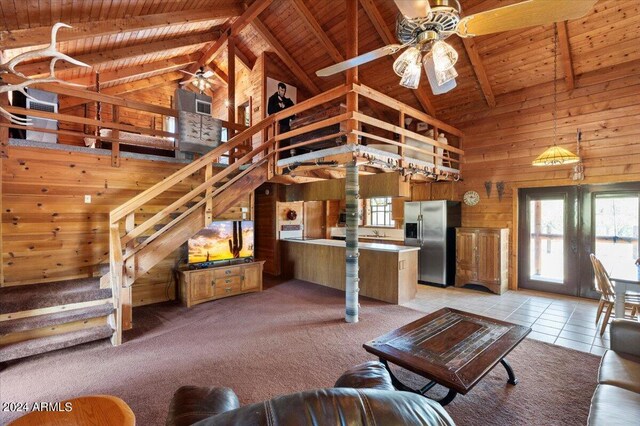 unfurnished living room with wood ceiling, wooden walls, and carpet flooring