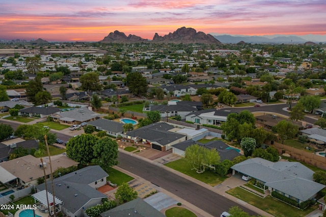 aerial view at dusk featuring a mountain view