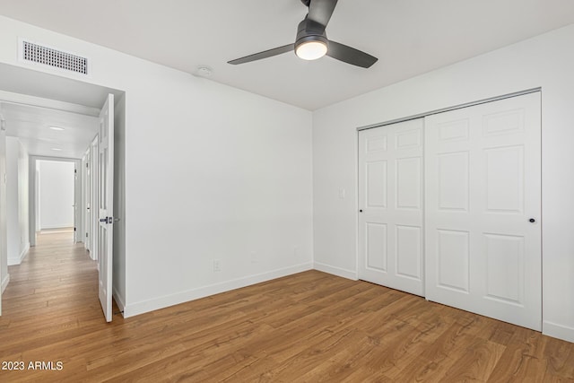 unfurnished bedroom with a closet, ceiling fan, and light wood-type flooring