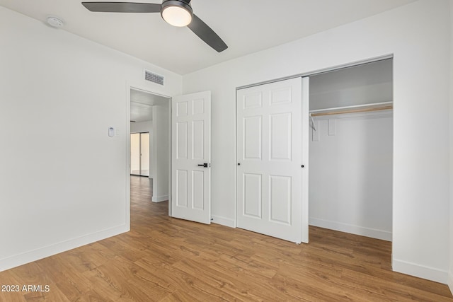 unfurnished bedroom featuring a closet, ceiling fan, and light hardwood / wood-style flooring