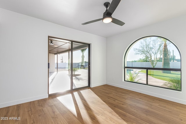 spare room featuring hardwood / wood-style flooring and plenty of natural light