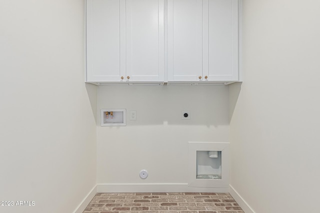 laundry room featuring washer hookup, cabinets, hookup for an electric dryer, and hookup for a gas dryer