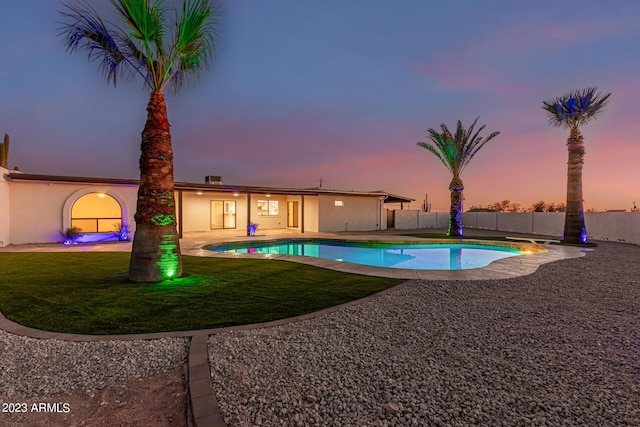 pool at dusk with a yard