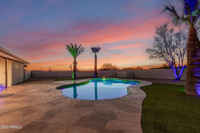 pool at dusk with a patio