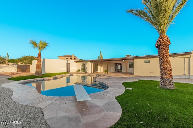 view of pool with a lawn, a diving board, and a patio