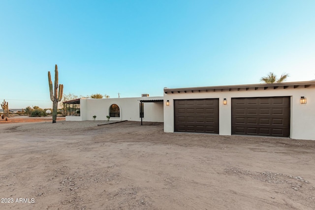 southwest-style home featuring a garage