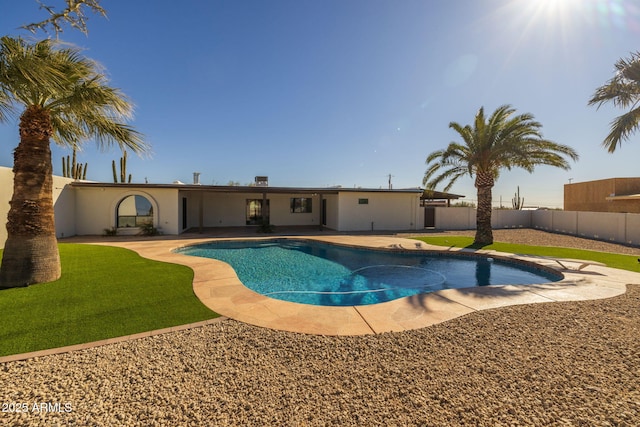 view of swimming pool with a yard and a patio