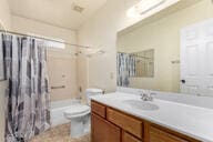 full bath featuring vanity, toilet, and a shower with curtain