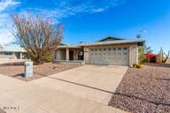 ranch-style home featuring a garage and concrete driveway