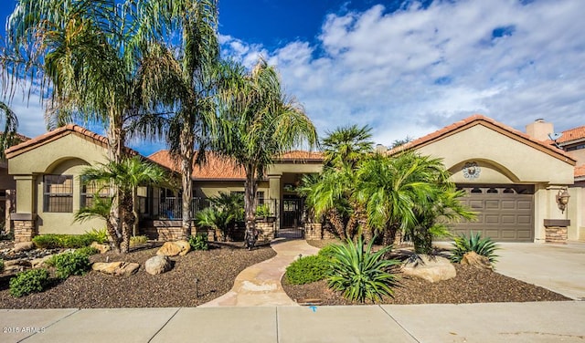 16446 N 59th St, Scottsdale, AZ 85254 - mediterranean / spanish house with a tile roof, concrete driveway, a garage, and stucco siding