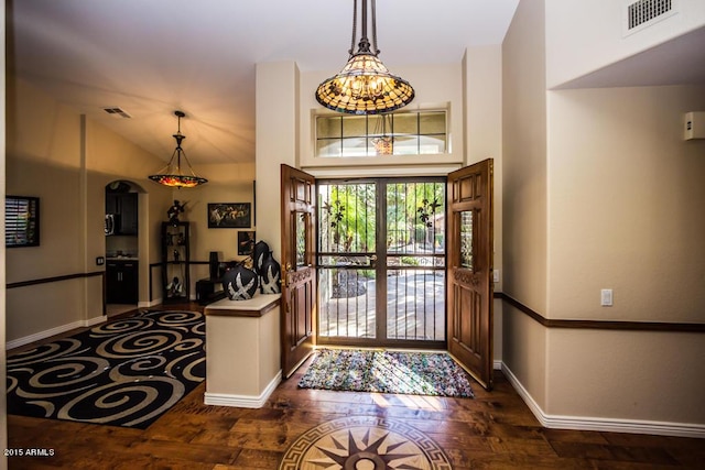16446 N 59th St, Scottsdale, AZ 85254 - foyer entrance with visible vents, baseboards, lofted ceiling, arched walkways, and dark wood-style floors