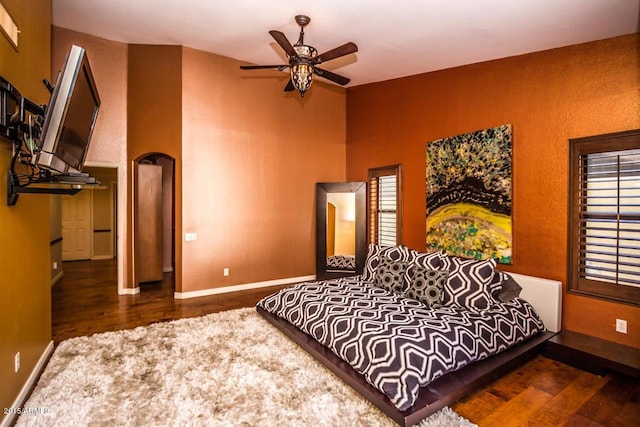 16446 N 59th St, Scottsdale, AZ 85254 - bedroom with a ceiling fan, wood finished floors, baseboards, and arched walkways