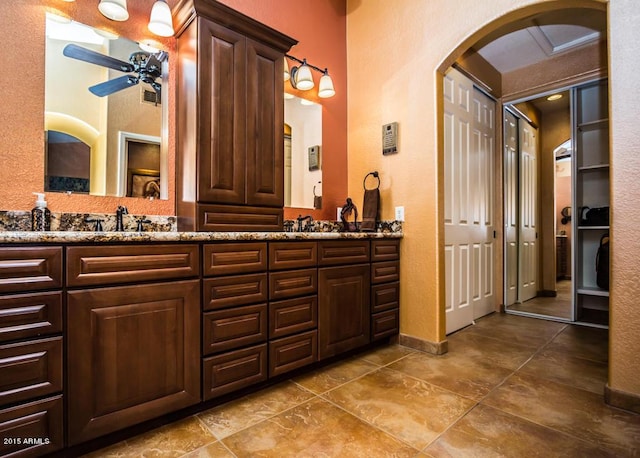 16446 N 59th St, Scottsdale, AZ 85254 - full bathroom with ceiling fan, double vanity, baseboards, and a sink