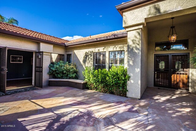 16446 N 59th St, Scottsdale, AZ 85254 - property entrance featuring stucco siding, a tile roof, and a patio