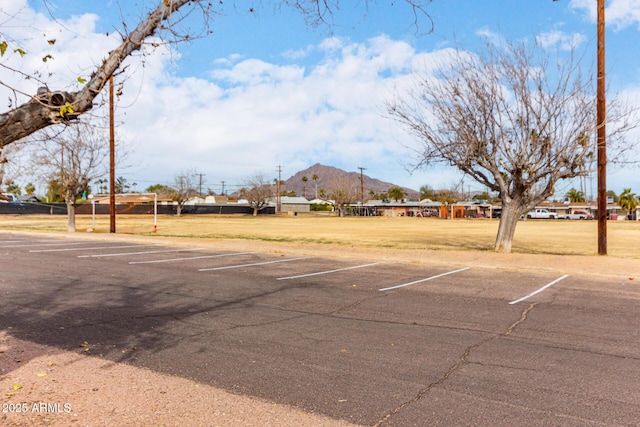 uncovered parking lot featuring a mountain view