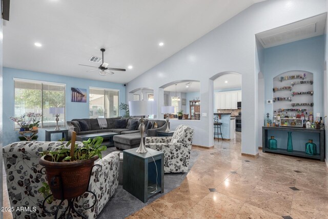13629 W San Miguel Ave, Litchfield Park, AZ 85340 - living room featuring a ceiling fan, recessed lighting, arched walkways, baseboards, and high vaulted ceiling