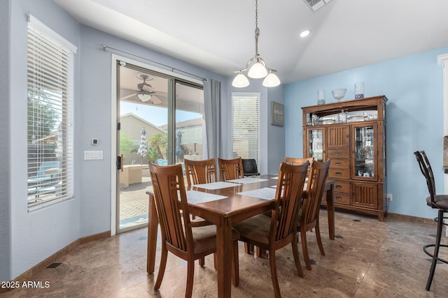 13629 W San Miguel Ave, Litchfield Park, AZ 85340 - dining area featuring baseboards, vaulted ceiling, and stone finish flooring
