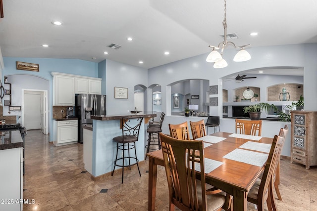 13629 W San Miguel Ave, Litchfield Park, AZ 85340 - dining area with arched walkways, a ceiling fan, vaulted ceiling, recessed lighting, and a chandelier