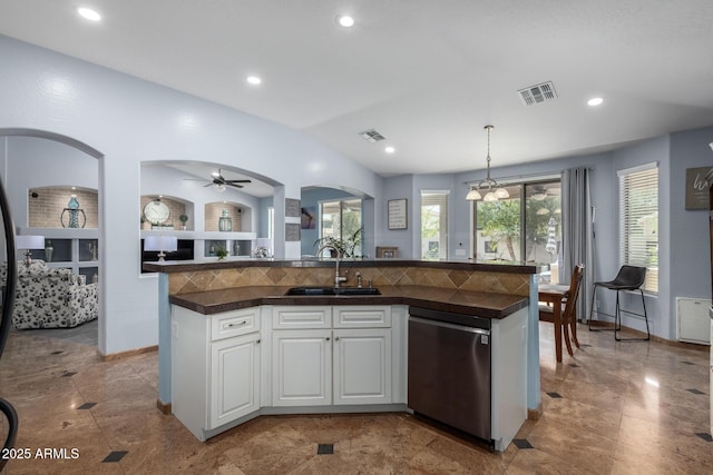 13629 W San Miguel Ave, Litchfield Park, AZ 85340 - kitchen with stainless steel dishwasher, a sink, dark countertops, white cabinets, and decorative light fixtures